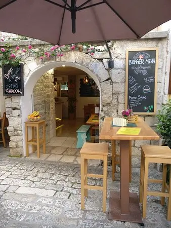 Stone arch terrace at Miki's Food & Bar in old town Trogir